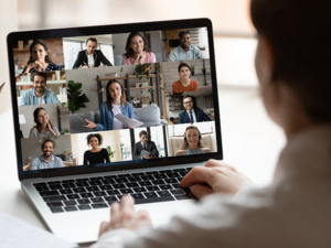 Person participating in a video conference on a laptop with Amherst Communications 700 Mbps Fiber Internet service